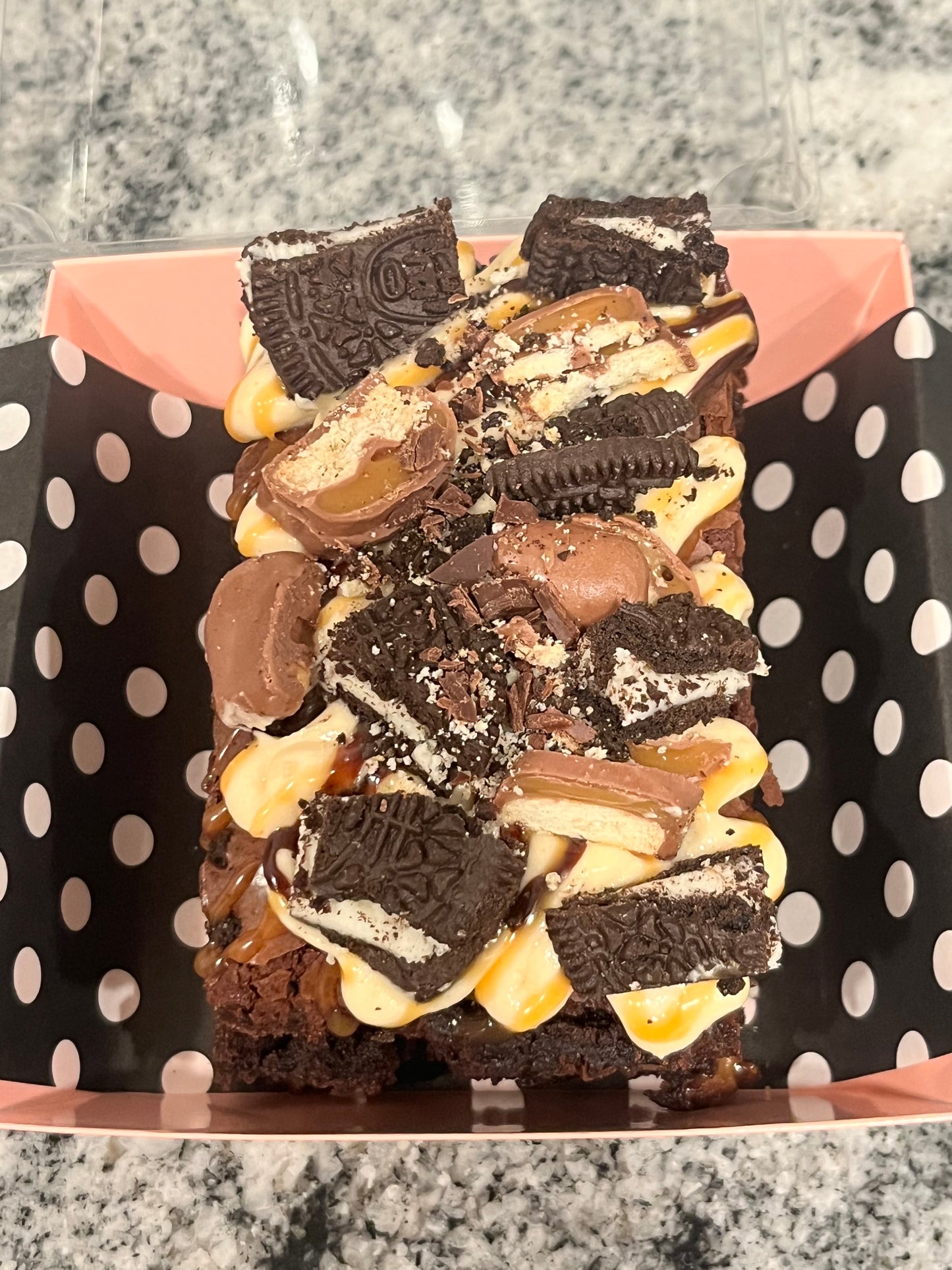 Boom Boom Brownie covered in salted caramel, Oreos and Twix candy.