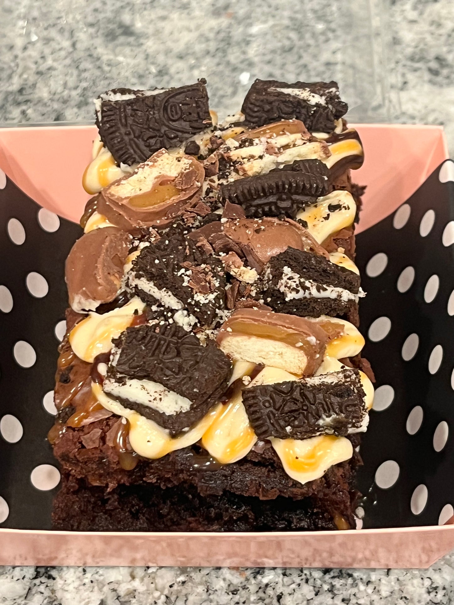Boom Boom Brownie covered in salted caramel, Oreos and Twix candy.