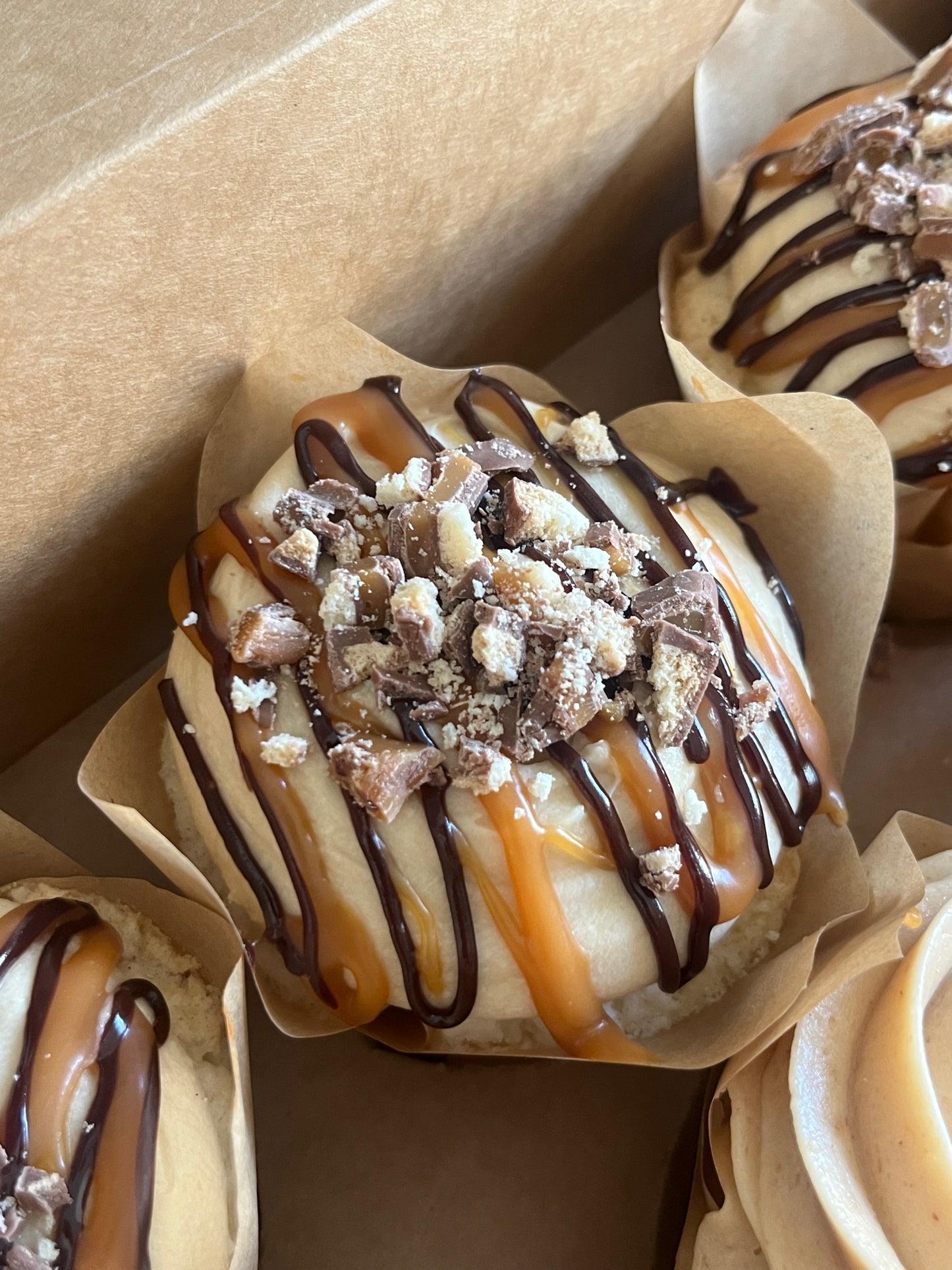 Vanilla Salted Caramel cupcakes in a bakers box.