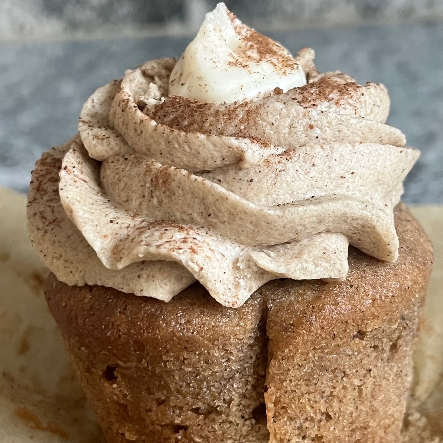 Again, another unwrapped Chai Honey Bear Cupcake with layers of frosting and cinnamon sprinkled on top.