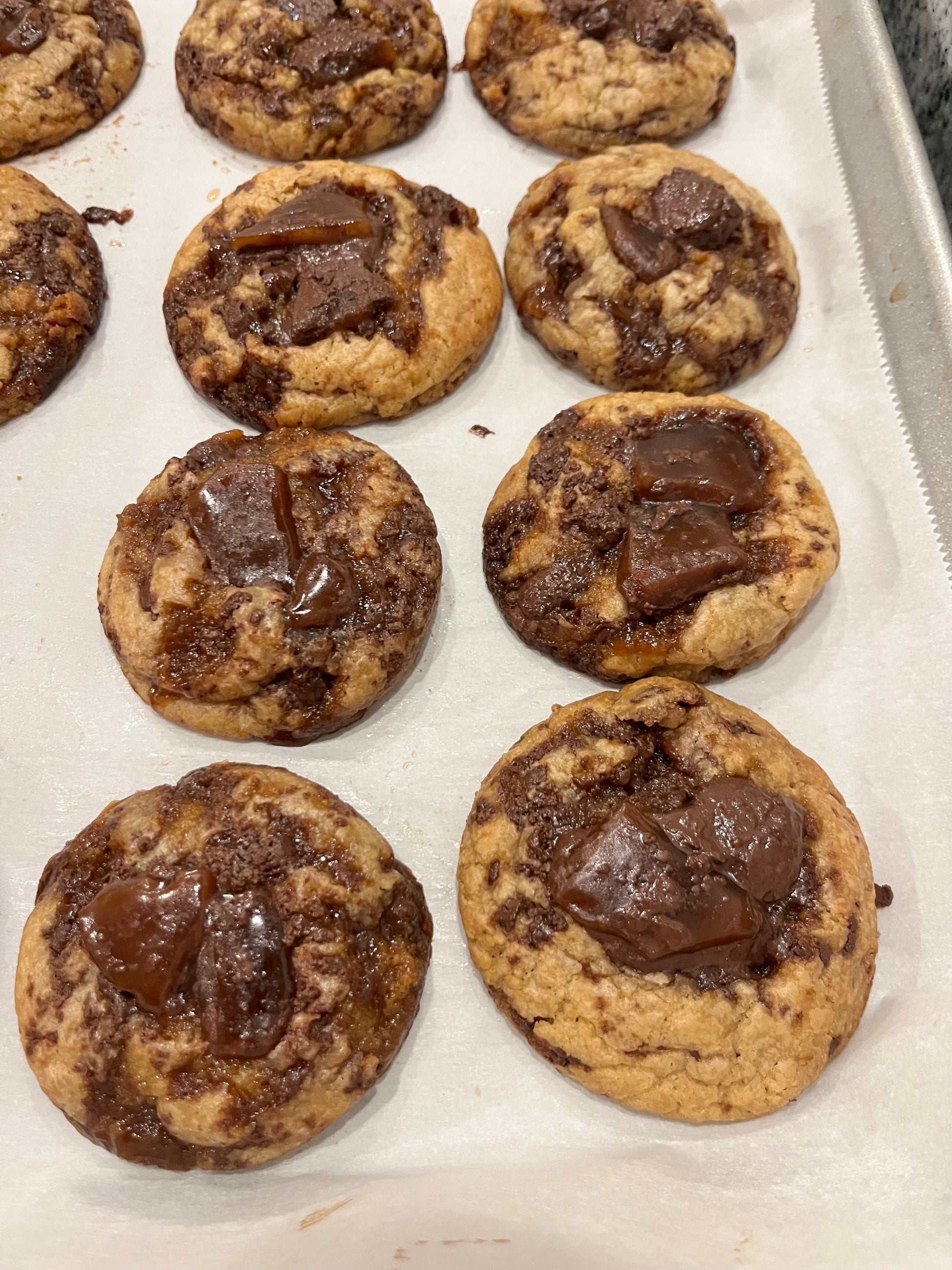 Get Ur Toffee On cookies without almonds lined up on a baking sheet.