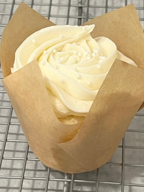 A closer image of the Very Vanilla cupcake on a bakery rack.