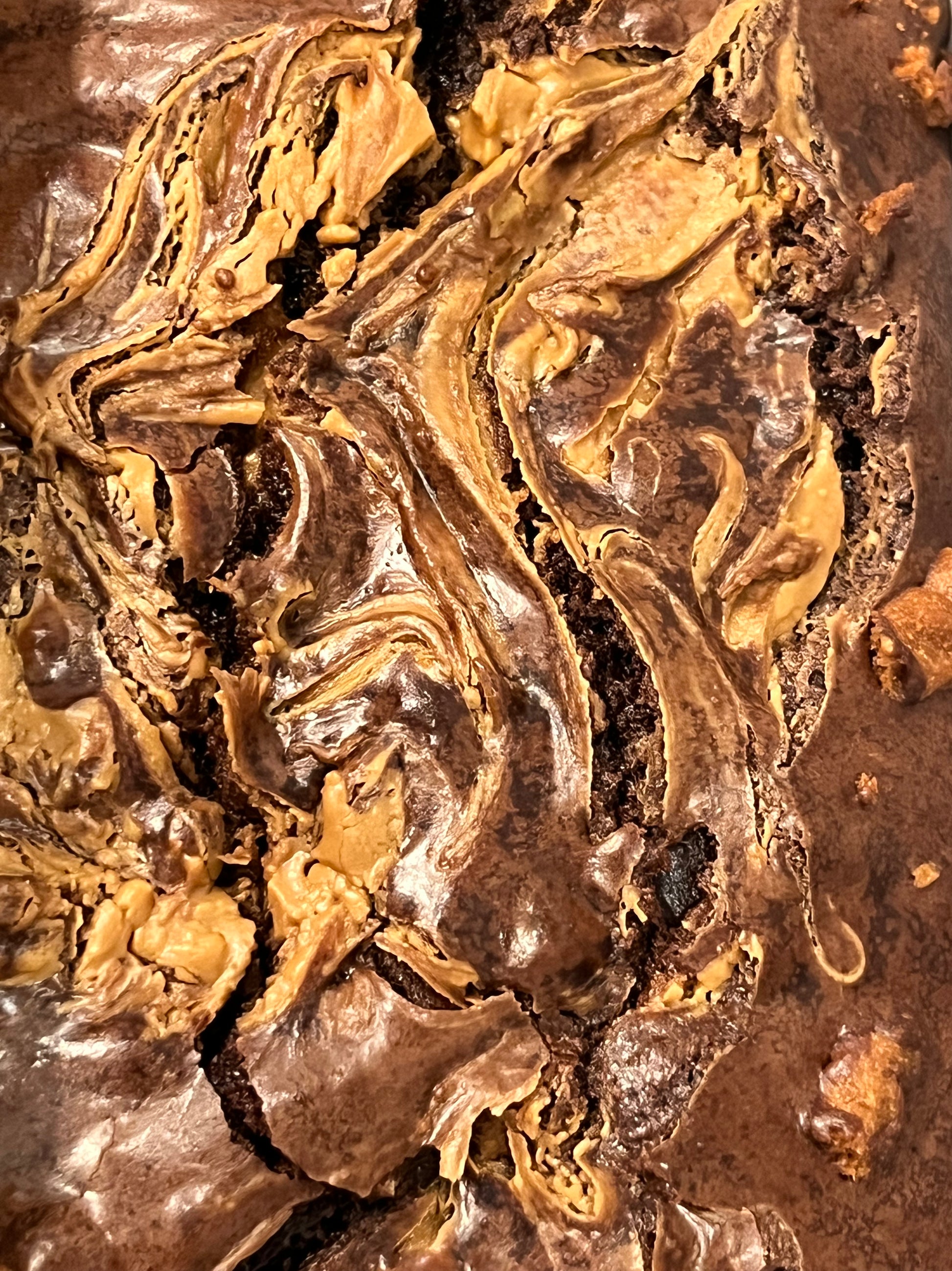 Close-up of a decadent chocolate peanut butter brownie with a swirl pattern.